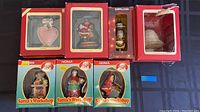 Photo showing all boxed Christmas ornaments from Hallmark, Kirkland, and Noma Santa's Workshop series.