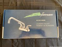 Closed box showing Metrostream laundry faucet model GE172073 chrome with product image and label.