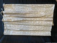 Roman blind laid out flat showing full width and length with visible embossed leafy texture.