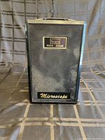 Front view of the vintage Sears branded microscope case with 900X zoom label