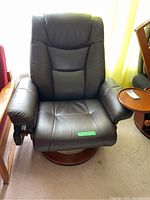 Front view of brown leather swivel armchair