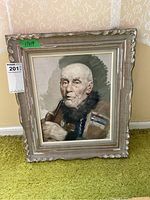 Full view of the framed painting on the floor, showing the elderly man with the pipe and the decorative wooden frame