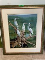 Full image of the original painting showing five cranes perched on tree branches in a marsh setting with a brown wooden frame and white matting.