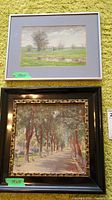 Photo showing both framed original paintings. Top painting of green field and pond, bottom painting of tree-lined path.