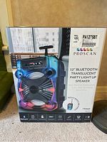 Front of the unopened Proscan speaker box showing vibrant light-up speaker image and model details.
