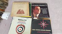 Top view of four vinyl LP covers: Mozart, Luciano Pavarotti, William Tell, and Czech opera favorites.