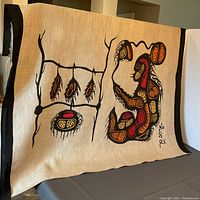 Full view of the silkscreen print on heavy linen fabric showing the indigenous art design with black borders and signature