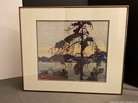 Front view of the framed print showing the artwork titled 'The Jack Pine' with matting and metal frame in copper/bronze tone.