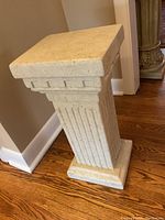 Full view of the Roman style plinth showing its height and column fluted design