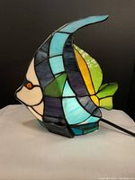 Side view of the colorful stained glass fish shaped lamp.