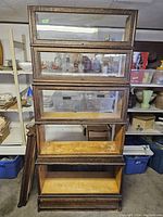 Front view of five-tier oak barrister bookcase with glass-front doors