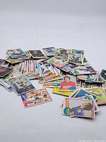 Photo of a scattered assortment of vintage hockey cards featuring various players and teams.