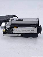 Side view showing the Canon Auto Zoom 318M label and zoom knob on camera body.