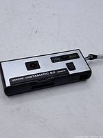 Front top view of the Kodak Pocket Instamatic 60 camera showing the model name, viewfinder, flash, and controls on the silver panel with black plastic body.