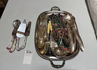 Full view of the tray with various utensils and the separate pie servers grouped on the side.