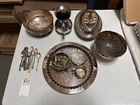 Overall assortment of serveware including bowls, tray, cups, and cutlery on a wooden surface.