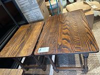 Photo of two wooden side tables showing different sizes and matching finish with visible wood grain and traditional turned legs.
