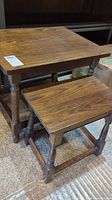 Two vintage wooden side tables showing their height and finish