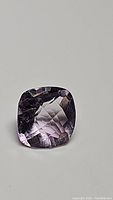 Photo of cushion checkerboard cut pink amethyst gemstone showcasing shape, color, cut and clarity.