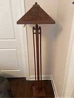 Full view of the floor lamp showing brown metal structure and pyramid shade