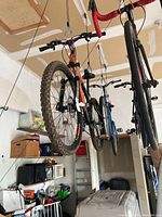 View of the front wheel and handlebar with knobby front tire and disc brakes, showing overall build and condition.