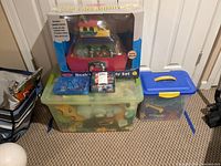 Overall shot showing boxed Noah’s Ark set atop container, Pokémon booster box in front and plastic bins of plush toys