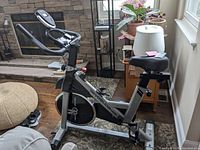 Side view of Yosuda fitness bike showing frame, seat, pedals and flywheel area.