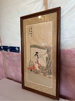 Frontal image of the antique Chinese painting showing the complete framed artwork, featuring a woman seated under a tree with inscriptions and seal marks above her.
