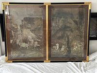 Front view of the two-panel framed print showing soldiers riding horses with a dark muted color palette, some reflective glare from glass.