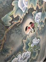 Close-up of painting showing two birds on a floral branch with white flowers and green leaves, detailed watercolour brushwork visible.