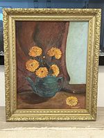 Full view of oil painting showing yellow flowers in green teapot with ornate gold frame