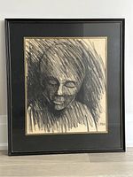 Full frontal view of the framed charcoal drawing showing the abstract portrait with black mat and wooden frame.