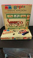 Photo showing two boxed sets: Animal Kingdom Snapics and Build-O-Fun Master Builder Set, stacked.