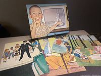 Eleven 1960s educational posters featuring children and adults in various scenarios, printed on thick cardboard.