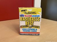 Front of sealed 1987 Fleer Major League Baseball's Best Sluggers vs Pitchers box showing yellow and blue colors with red highlights and text about 6 logo stickers and 44 trading cards.