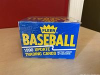 Sealed rectangular box of 1990 Fleer MLB Baseball Update Trading Cards with Logo Stickers visible from front side showing branding and item details.