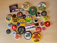 Lot of 33 assorted vintage buttons and pins shown in a grouped layout on a flat surface.