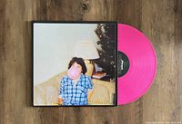 Photo showing Altameda Born Losers vinyl record in bright pink color partially pulled out of album jacket featuring the child with bubble gum cover art