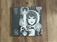 Front cover of the sealed 'Dreams' LP featuring black and white artistic design with faces and floral motifs.