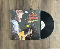 Front view of target album cover and visible black vinyl record partially extracted from jacket.