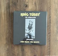 Sealed box set of King Tubby 'Dub From The Roots'. Black cover with image of King Tubby and yellow text.