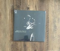 Front cover of Miles Davis 'Miles In Tokyo' vinyl record showing monochrome image of Miles Davis playing trumpet, sealed in shrink wrap.
