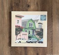 Front cover of sealed 2020 colored vinyl LP 'Uncommon Weather' by The Reds, Pinks, And Purples showing the album artwork with pastel houses and cars.