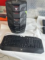 Front view of Acer Predator tower and wired Predator keyboard laid out