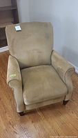 Front view of beige recliner chair showing cushioned seat and backrest