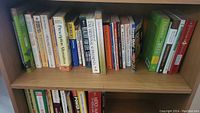 Photo showing a row of 27 healthcare-related books on a bookshelf, well organized and in good condition.