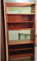 Full view of teak mid century bookcase showing shelves and overall structure