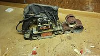 Overall view of the Sears Craftsman sander with sanding belts showing dusty condition and general wear