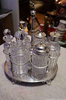 Full view of stand loaded with all six crystal bottles and faceted stoppers