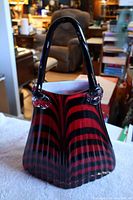 Front and side view showing stripes, purse shape and handle design